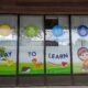 Playful window graphics pointing the way to the Cheshire Children's Museum entrance.